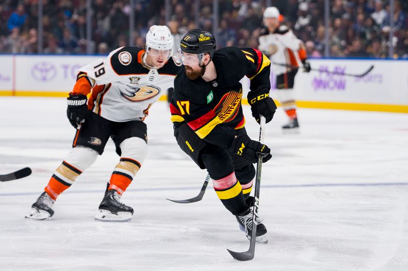 Nov 28, 2023; Vancouver, British Columbia, CAN; Anaheim Ducks forward Troy Terry (19) watches as Vancouver Canucks defenseman Filip Hronek (17) handles the puck  in the third period at Rogers Arena. Vancouver won 3-1. Mandatory Credit: Bob Frid-USA TODAY Sports