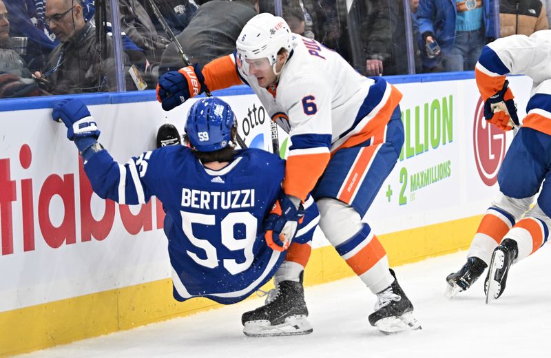 Feb 5, 2024; Toronto, Ontario, CAN;  New York Islanders defenseman Ryan Pulock (6) knocks down Toronto Maple Leafs forward Tyler Bertuzzi (59) with a bodycheck in the first period at Scotiabank Arena. Mandatory Credit: Dan Hamilton-USA TODAY Sports