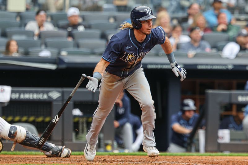 May 4, 2025; Bronx, New York, USA; Tampa Bay Rays right fielder Travis Jankowski (20) singles during the sixth inning against the New York Yankees at Yankee Stadium. Mandatory Credit: Vincent Carchietta-Imagn Images
