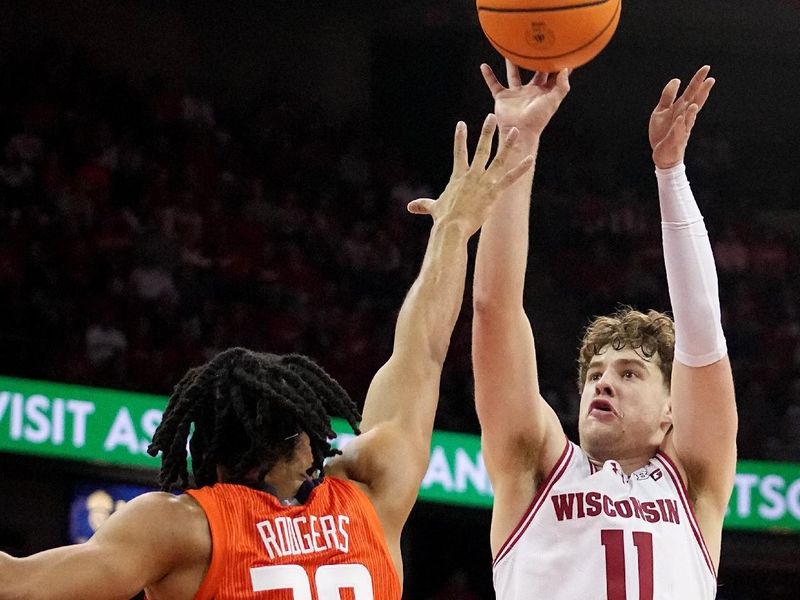 Mar 2, 2024; Madison, WI, USA;  Wisconsin guard Max Klesmit (11) misses a basket during the second half of their game Saturday, March 2, 2024 at the Kohl Center in Madison, Wisconsin.  Mandatory Credit: Mark Hoffman-USA TODAY Sports
