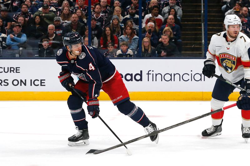 Oct 15, 2024; Columbus, Ohio, USA; Columbus Blue Jackets center Cole Sillinger (4) lifts a backhand shot on goal against the Florida Panthers during the second period at Nationwide Arena. Mandatory Credit: Russell LaBounty-Imagn Images