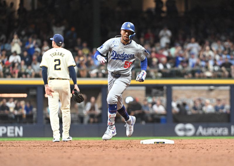 Aug 12, 2024; Milwaukee, Wisconsin, USA; Los Angeles Dodgers right field Mookie Betts (50) rounds the bases after hitting a home run against the Milwaukee Brewers at American Family Field. Mandatory Credit: Michael McLoone-USA TODAY Sports