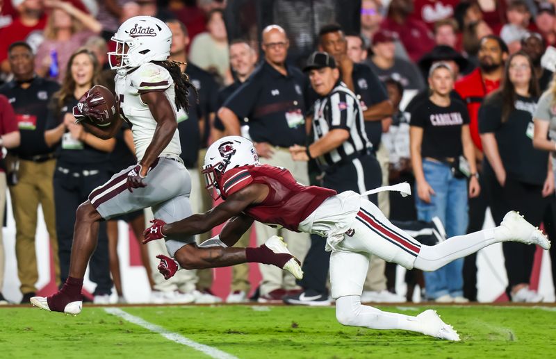 Sep 23, 2023; Columbia, South Carolina, USA; Mississippi State Bulldogs wide receiver Lideatrick Griffin (5) makes a 65-yard reception over South Carolina Gamecocks defensive back O'Donnell Fortune (3) in the second quarter at Williams-Brice Stadium. Mandatory Credit: Jeff Blake-USA TODAY Sports