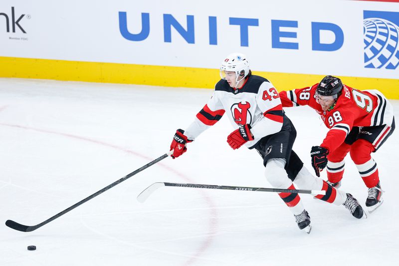 Nov 12, 2025; Chicago, Illinois, USA; New Jersey Devils defenseman Luke Hughes (43) defends against Chicago Blackhawks center Connor Bedard (98) during the first period at United Center. Mandatory Credit: Kamil Krzaczynski-Imagn Images Nov 12, 2025; Chicago, Illinois, USA; New Jersey Devils defenseman Luke Hughes (43) defends against Chicago Blackhawks center Connor Bedard (98) during the first period at United Center. Mandatory Credit: Kamil Krzaczynski-Imagn Images