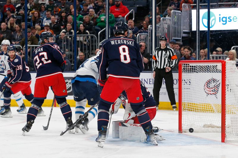 Mar 17, 2024; Columbus, Ohio, USA; Winnipeg Jets left wing Kyle Connor (81) slides the puck past Columbus Blue Jackets goalie Elvis Merzlikins (90) for a goal during the first period at Nationwide Arena. Mandatory Credit: Russell LaBounty-USA TODAY Sports