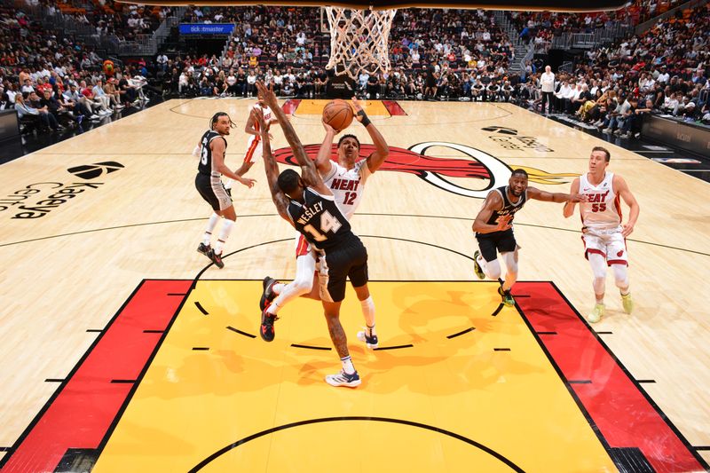 MIAMI, FL - OCTOBER 15: Dru Smith #12 of the Miami Heat drives to the basket during the game against the San Antonio Spurs during a NBA preseason game on October 15, 2024 at Kaseya Center in Miami, Florida. NOTE TO USER: User expressly acknowledges and agrees that, by downloading and or using this Photograph, user is consenting to the terms and conditions of the Getty Images License Agreement. Mandatory Copyright Notice: Copyright 2024 NBAE (Photo by Jesse D. Garrabrant/NBAE via Getty Images)