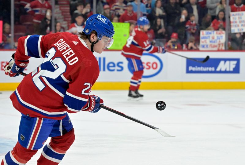 Apr 6, 2024; Montreal, Quebec, CAN; Montreal Canadiens forward Cole Caufield (22) juggles a puck during the warmup period before the game against the Toronto Maple Leafs at the Bell Centre. Mandatory Credit: Eric Bolte-USA TODAY Sports