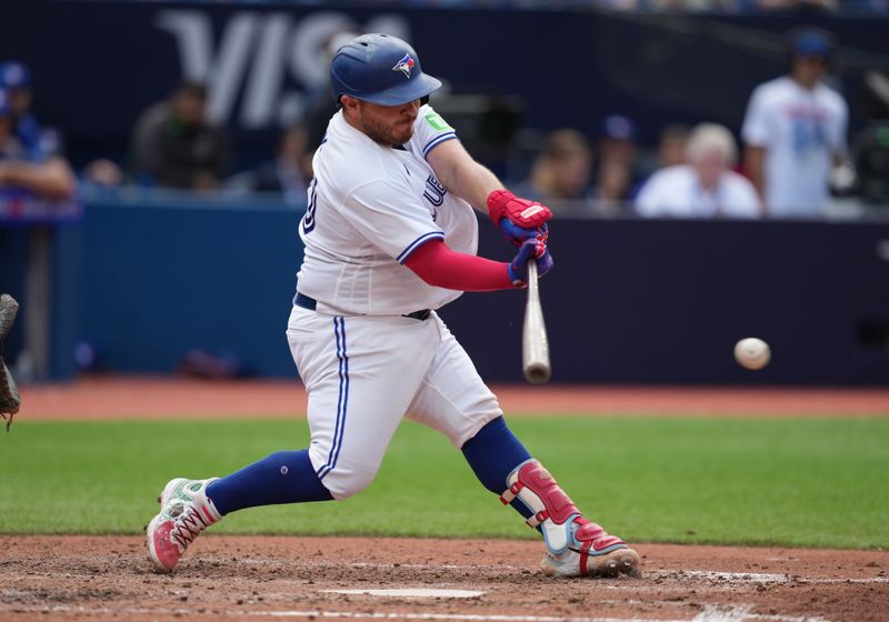 Sep 10, 2023; Toronto, Ontario, CAN; Toronto Blue Jays catcher Alejandro Kirk (30) hits a single against the Kansas City Royals during the eighth inning at Rogers Centre. Mandatory Credit: Nick Turchiaro-USA TODAY Sports