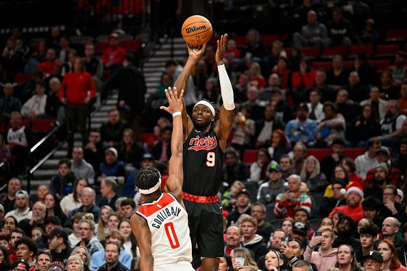 PORTLAND, OREGON - DECEMBER 21: Jerami Grant #9 of the Portland Trail Blazers shoots a three point basket over Bilal Coulibaly #0 of the Washington Wizards during the third quarter of the game at the Moda Center on December 21, 2023 in Portland, Oregon. The Washington Wizards won 118-117. NOTE TO USER: User expressly acknowledges and agrees that, by downloading and or using this photograph, User is consenting to the terms and conditions of the Getty Images License Agreement. (Photo by Alika Jenner/Getty Images)