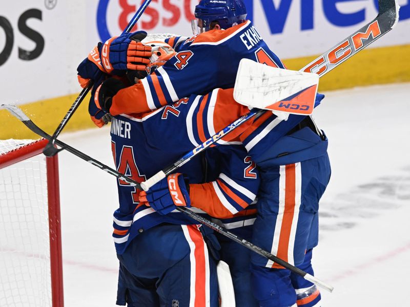 Jun 2, 2024; Edmonton, Alberta, CAN; Edmonton Oilers goalie Stuart Skinner (74) celebrate their win with Oilers defenceman Eric Bouchard (2) and Oilkers defenceman Mattias Ekholm (14) during the third period in game six of the Western Conference Final of the 2024 Stanley Cup Playoffs at Rogers Place. Mandatory Credit: Walter Tychnowicz-USA TODAY Sports