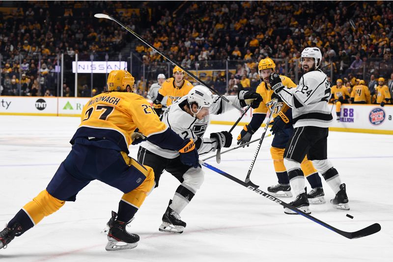 Jan 31, 2024; Nashville, Tennessee, USA; Los Angeles Kings left wing Trevor Moore (12) loses the puck as he is defended by Nashville Predators defenseman Ryan McDonagh (27) during the second period at Bridgestone Arena. Mandatory Credit: Christopher Hanewinckel-USA TODAY Sports