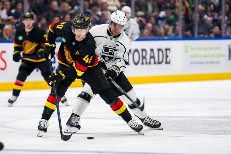 Mar 25, 2024; Vancouver, British Columbia, CAN; Los Angeles Kings forward Anze Kopitar (11) checks Vancouver Canucks forward Elias Pettersson (40) in the second period  at Rogers Arena. Mandatory Credit: Bob Frid-USA TODAY Sports