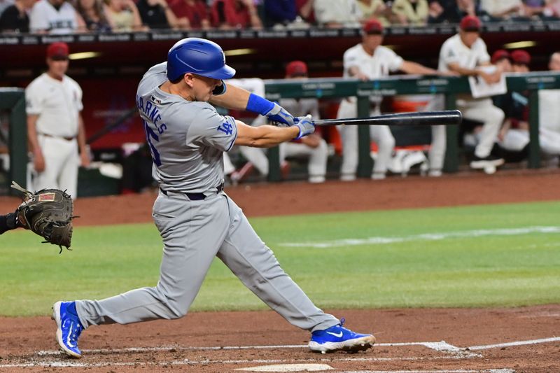 May 1, 2024; Phoenix, Arizona, USA;  Los Angeles Dodgers catcher Austin Barnes (15) hits an RBI double in the second inning against the Arizona Diamondbacks at Chase Field. Mandatory Credit: Matt Kartozian-USA TODAY Sports