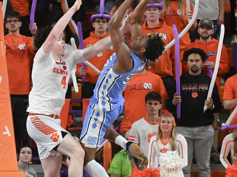 Jan 6, 2024; Clemson, South Carolina, USA; Clemson junior forward Ian Schieffelin (4) defends University of North Carolina forward Harrison Ingram (55) during the second half at Littlejohn Coliseum. Mandatory Credit: Ken Ruinard-USA TODAY Sports