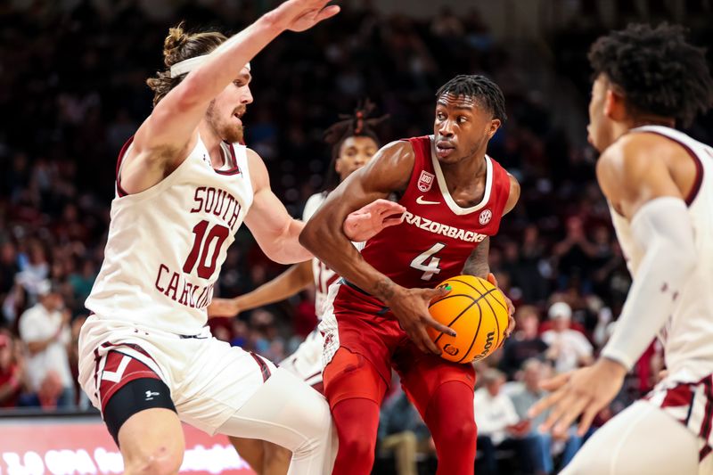 Feb 4, 2023; Columbia, South Carolina, USA; Arkansas Razorbacks guard Davonte Davis (4) looks to get around South Carolina Gamecocks forward Hayden Brown (10) in the second half at Colonial Life Arena. Mandatory Credit: Jeff Blake-USA TODAY Sports