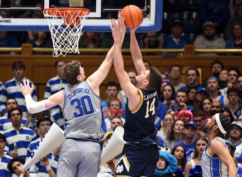 Feb 14, 2023; Durham, North Carolina, USA;  Duke Blue Devils center Kyle Filipowski(30) blocks the shot of Notre Dame Fighting Irish forward Nate Laszewski (14) during the second half at Cameron Indoor Stadium.  The Blue Devils won 68-64. Mandatory Credit: Rob Kinnan-USA TODAY Sports