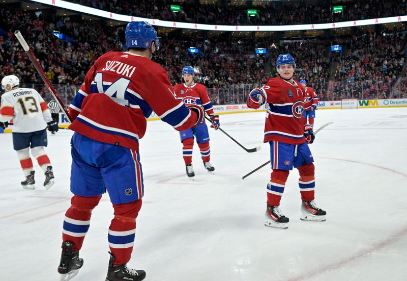 Apr 2, 2024; Montreal, Quebec, CAN; Montreal Canadiens forward Nick Suzuki (14) celebrates with teammate forward Cole Caufield (22) after scoring a goal against the Florida Panthers during the second period at the Bell Centre. Mandatory Credit: Eric Bolte-USA TODAY Sports