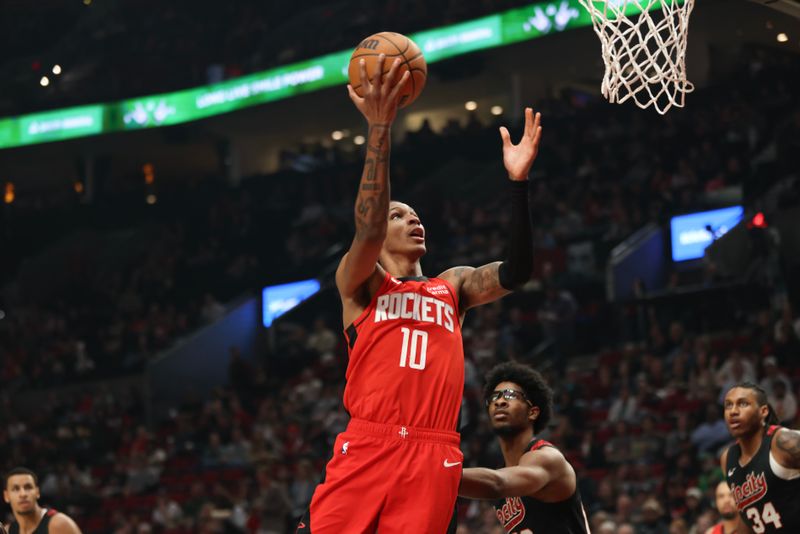 PORTLAND, OREGON - APRIL 12: Jabari Smith Jr. #10 of the Houston Rockets drives to the basket against the Portland Trail Blazers at Moda Center on April 12, 2024 in Portland, Oregon. NOTE TO USER: User expressly acknowledges and agrees that, by downloading and or using this photograph, User is consenting to the terms and conditions of the Getty Images License Agreement.? (Photo by Amanda Loman/Getty Images)