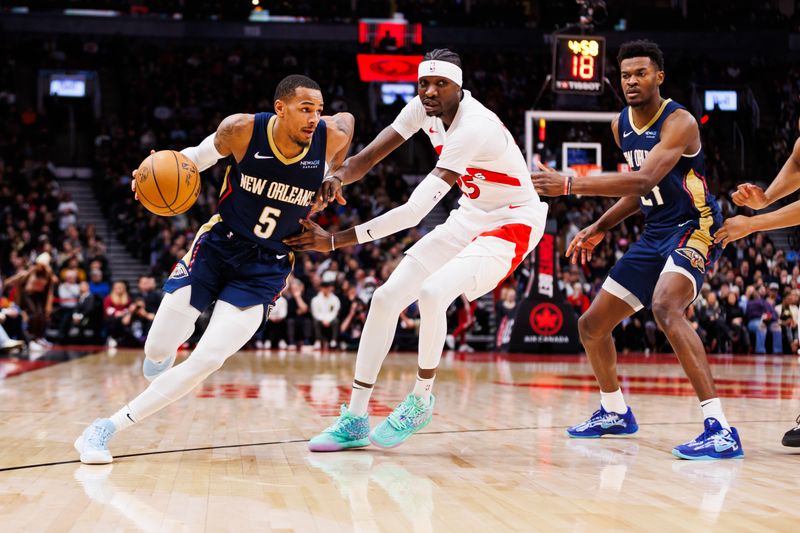 TORONTO, CANADA - JANUARY 27: Dejounte Murray #5 of the New Orleans Pelicans dribbles against Chris Boucher #25 of the Toronto Raptors during second half of their NBA game at Scotiabank Arena on January 27, 2025 in Toronto, Canada. NOTE TO USER: User expressly acknowledges and agrees that, by downloading and or using this photograph, User is consenting to the terms and conditions of the Getty Images License Agreement. (Photo by Cole Burston/Getty Images)