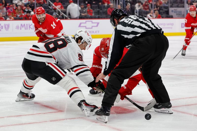 Nov 30, 2023; Detroit, Michigan, USA; Chicago Blackhawks center Connor Bedard (98) and Detroit Red Wings center Andrew Copp (18) face off in the second period at Little Caesars Arena. Mandatory Credit: Rick Osentoski-USA TODAY Sports