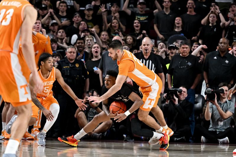 Feb 21, 2023; College Station, Texas, USA; Texas A&M Aggies guard Wade Taylor IV (4) is fouled by Tennessee Volunteers guard Santiago Vescovi (25) during the second half at Reed Arena. Mandatory Credit: Maria Lysaker-USA TODAY Sports