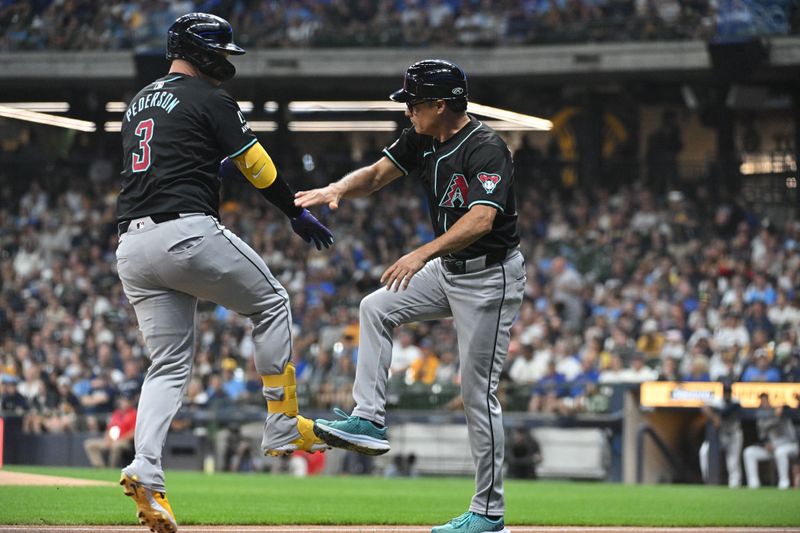 Sep 21, 2024; Milwaukee, Wisconsin, USA; Arizona Diamondbacks designated hitter Joc Pederson (3) is congratulated by Arizona Diamondbacks third base coach Tony Perezchica (21) after hitting a home run against the Milwaukee Brewers in the first inning at American Family Field. Mandatory Credit: Michael McLoone-Imagn Images