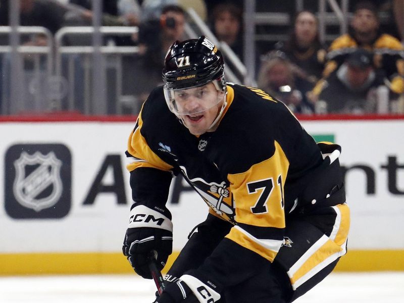 Oct 18, 2024; Pittsburgh, Pennsylvania, USA;  Pittsburgh Penguins center Evgeni Malkin (71) skates up ice with the puck against the Carolina Hurricanes during the third period at PPG Paints Arena. Mandatory Credit: Charles LeClaire-Imagn Images