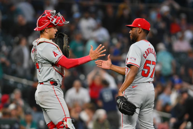 Jul 23, 2024; Seattle, Washington, USA; Los Angeles Angels catcher Logan O'Hoppe (14) and relief pitcher Roansy Contreras (57) celebrate after defeating the Seattle Mariners at T-Mobile Park. Mandatory Credit: Steven Bisig-USA TODAY Sports