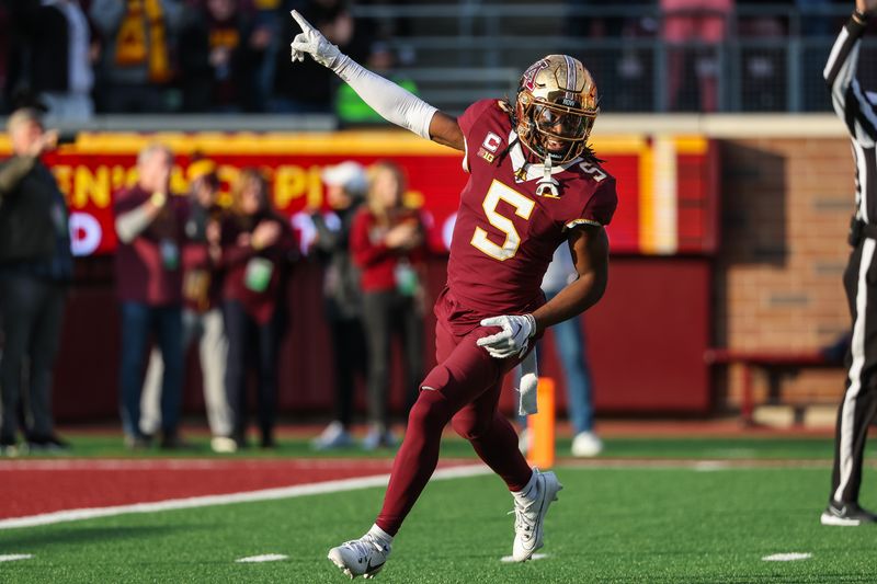 Nov 4, 2023; Minneapolis, Minnesota, USA; Minnesota Golden Gophers defensive back Justin Walley (5) celebrates a fumble recovery by defensive lineman Chris Collins (13) during the second half against the Illinois Fighting Illini at Huntington Bank Stadium. Mandatory Credit: Matt Krohn-USA TODAY Sports