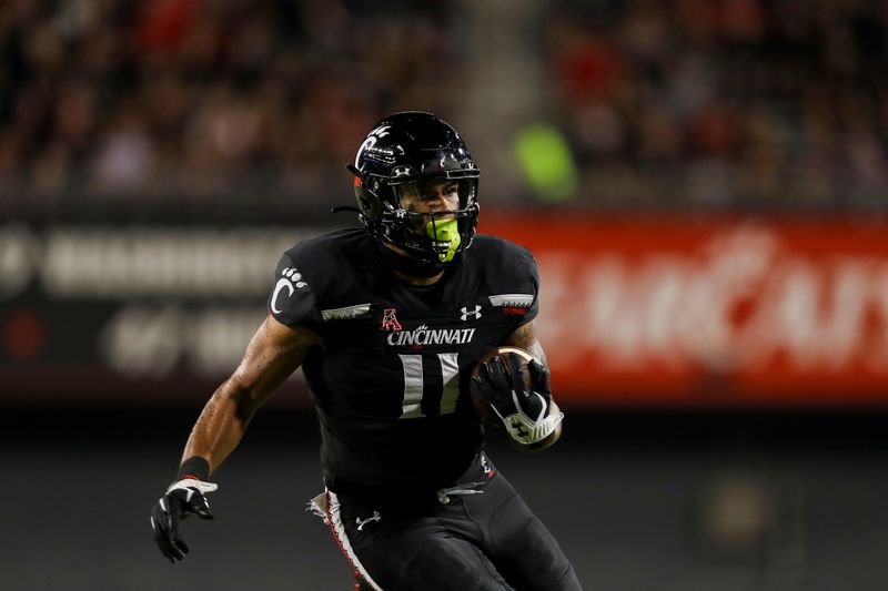 Oct 8, 2021; Cincinnati, Ohio, USA; Cincinnati Bearcats tight end Leonard Taylor (11) runs with the ball against the Temple Owls in the first half at Nippert Stadium. Mandatory Credit: Katie Stratman-USA TODAY Sports