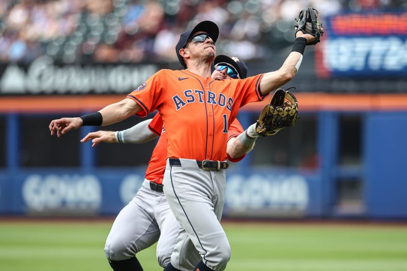 Jun 30, 2024; New York City, New York, USA;  Houston Astros first baseman Mauricio Dubon (14) jumps in front of Houston Astros right fielder Trey Cabbage (38) to catch a pop up in the eighth inning against the New York Mets at Citi Field. Mandatory Credit: Wendell Cruz-USA TODAY Sports