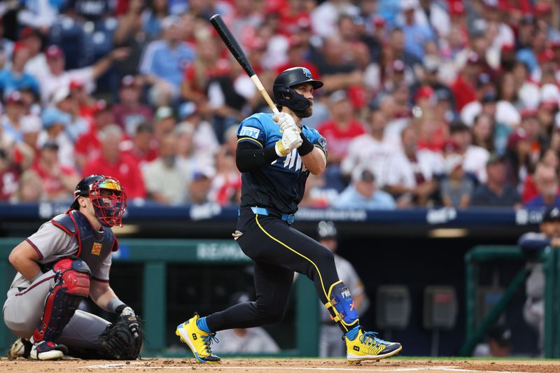 Aug 30, 2024; Philadelphia, Pennsylvania, USA; Philadelphia Phillies first base Bryce Harper (3) hits a double in front of Atlanta Braves catcher Sean Murphy (12) during the first inning at Citizens Bank Park. Mandatory Credit: Bill Streicher-USA TODAY Sports