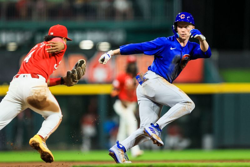 Jul 31, 2024; Cincinnati, Ohio, USA; Chicago Cubs outfielder Pete Crow-Armstrong (52) gets tagged out at third by Cincinnati Reds third baseman Santiago Espinal (4) in the seventh inning at Great American Ball Park. Mandatory Credit: Katie Stratman-USA TODAY Sports