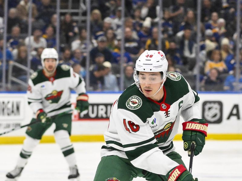 Nov 19, 2024; St. Louis, Missouri, USA;  Minnesota Wild defenseman Jared Spurgeon (46) controls the puck against the St. Louis Blues during the first period at Enterprise Center. Mandatory Credit: Jeff Curry-Imagn Images