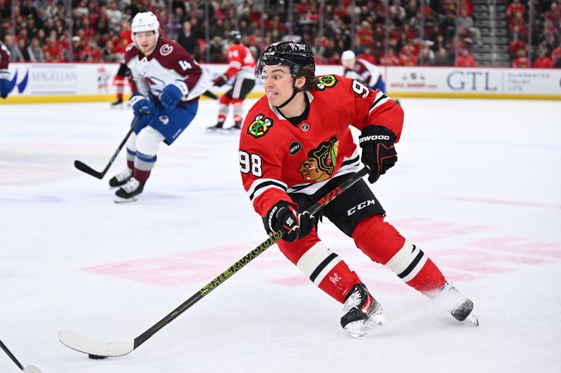 Dec 19, 2023; Chicago, Illinois, USA; Chicago Blackhawks forward Connor Bedard (98) controls the puck in the first period against the Colorado Avalanche at United Center. Mandatory Credit: Jamie Sabau-USA TODAY Sports