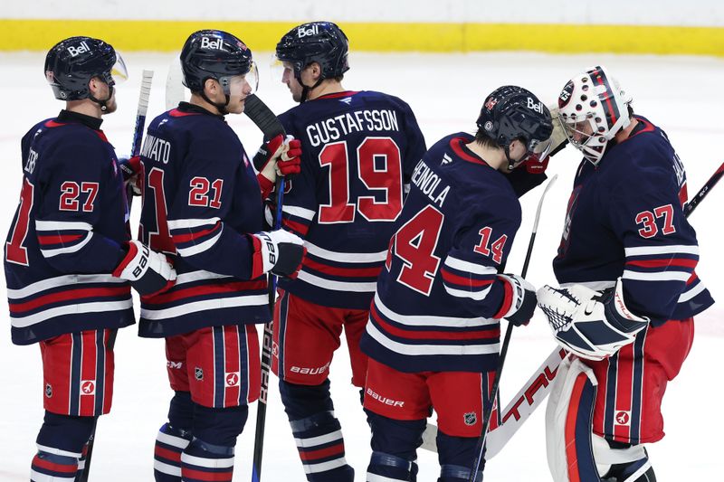 Jan 16, 2025; Winnipeg, Manitoba, CAN; Winnipeg Jets players celebrate their victory over the Seattle Kraken at Canada Life Centre. Mandatory Credit: James Carey Lauder-Imagn Images