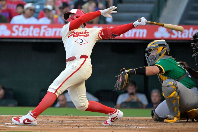 Jun 24, 2024; Anaheim, California, USA;  Los Angeles Angels left fielder Taylor Ward (3) hits a two-run home run in the first inning against the Oakland Athletics at Angel Stadium. Mandatory Credit: Jayne Kamin-Oncea-USA TODAY Sports