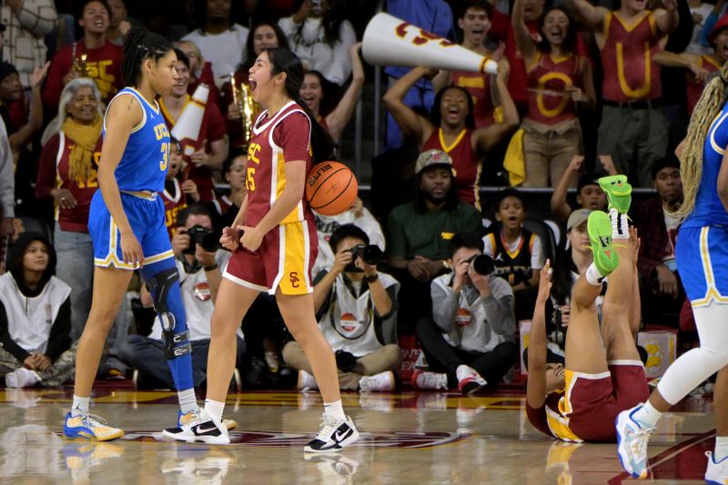 Jan 14, 2024; Los Angeles, California, USA; USC Trojans guard Kayla Padilla (45) celebrates as UCLA Bruins guard Camryn Brown (35) walks off the court at the end of the game at Galen Center. Mandatory Credit: Jayne Kamin-Oncea-USA TODAY Sports