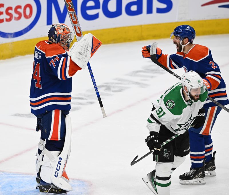 Jun 2, 2024; Edmonton, Alberta, CAN; Edmonton Oilers goalie Stuart Skinner (74) celebrate their win with Oilers defenceman Eric Bouchard (2) while Dallas Stars centre Tyler Seguin (91) skates away during the third period in game six of the Western Conference Final of the 2024 Stanley Cup Playoffs at Rogers Place. Mandatory Credit: Walter Tychnowicz-USA TODAY Sports