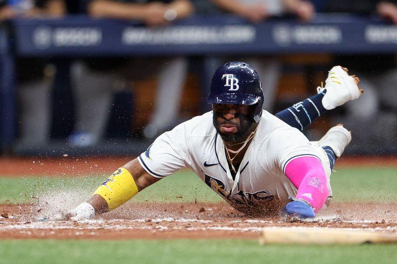 Jul 11, 2024; St. Petersburg, Florida, USA; Tampa Bay Rays first baseman Yandy Diaz (2) scores a run against the New York Yankees in the third inning  at Tropicana Field. Mandatory Credit: Nathan Ray Seebeck-USA TODAY Sports