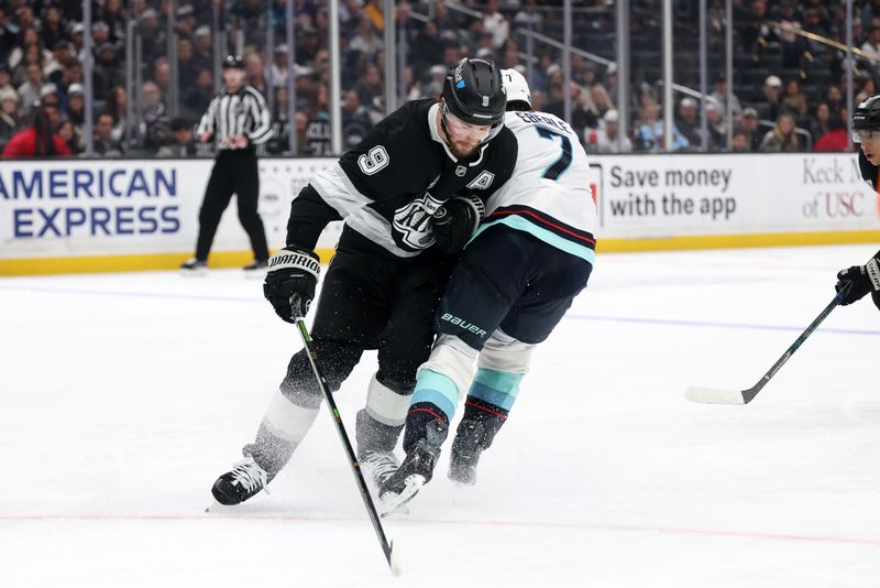 Feb 4, 2026; Los Angeles, California, USA;  Los Angeles Kings right wing Adrian Kempe (9) checks Seattle Kraken right wing Jordan Eberle (7) during the third period at Crypto.com Arena. Mandatory Credit: Kiyoshi Mio-Imagn Images