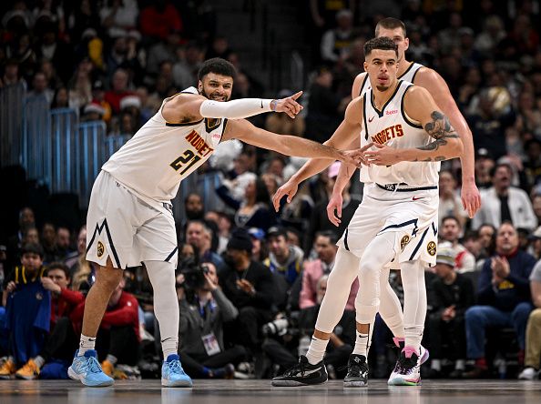 DENVER, CO - DECEMBER 25: Jamal Murray (27) and Nikola Jokic (15) of the Denver Nuggets direct teammate Michael Porter Jr. (1) where to be on defenses against the Golden State Warriors during the fourth quarter of the Nuggets' 120-114 win at Ball Arena in Denver on Monday, December 25, 2023. (Photo by AAron Ontiveroz/The Denver Post)