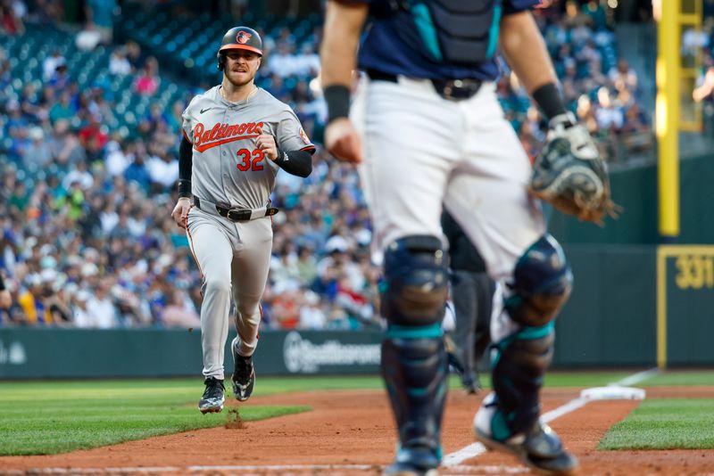 Jul 3, 2024; Seattle, Washington, USA; Baltimore Orioles first baseman Ryan O'Hearn (32) scores a run against the Seattle Mariners during the third inning at T-Mobile Park. Mandatory Credit: Joe Nicholson-USA TODAY Sports