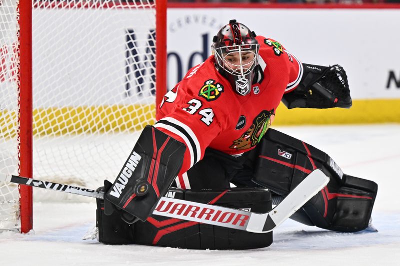 Jan 13, 2024; Chicago, Illinois, USA;  Chicago Blackhawks goaltender Petr Mrazek (34) makes a save in the second period against the Dallas Stars at United Center. Mandatory Credit: Jamie Sabau-USA TODAY Sports