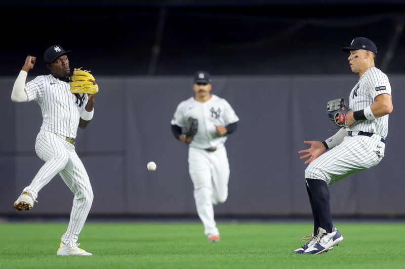Sep 5, 2025; Bronx, New York, USA; A single hit by Toronto Blue Jays shortstop Bo Bichette (not pictured) falls between New York Yankees second baseman Jazz Chisholm Jr. (13) and center fielder Trent Grisham (12) and right fielder Aaron Judge (99) during the fifth inning at Yankee Stadium. Mandatory Credit: Brad Penner-Imagn Images