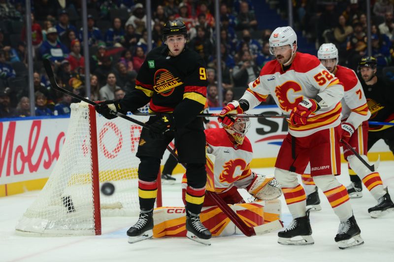 Nov 23, 2025; Vancouver, British Columbia, CAN;  Vancouver Canucks left wing Evander Kane (91) watches a loose puck during the third period against the Calgary Flames at Rogers Arena. Mandatory Credit: Simon Fearn-Imagn Images
