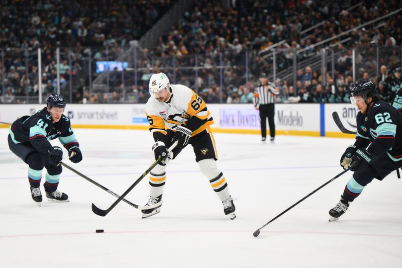 Jan 25, 2025; Seattle, Washington, USA; Pittsburgh Penguins defenseman Erik Karlsson (65) plays the puck during the second period against the Seattle Kraken at Climate Pledge Arena. Mandatory Credit: Steven Bisig-Imagn Images