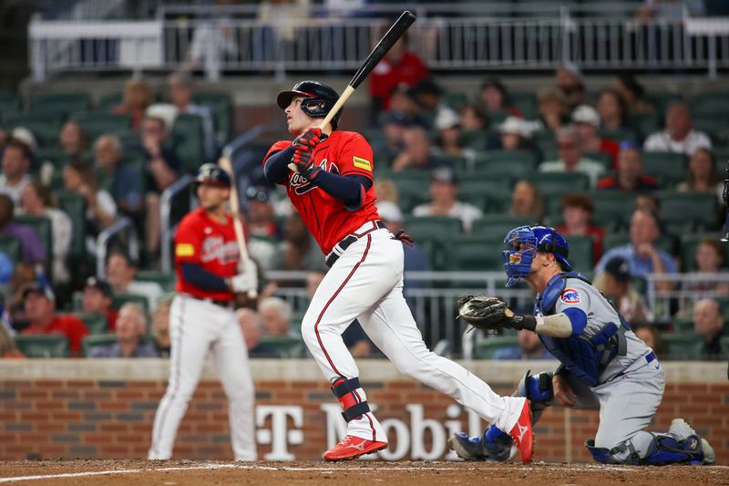 Sep 28, 2023; Atlanta, Georgia, USA; Atlanta Braves third baseman Austin Riley (27) hits a triple against the Chicago Cubs in the third inning at Truist Park. Mandatory Credit: Brett Davis-USA TODAY Sports