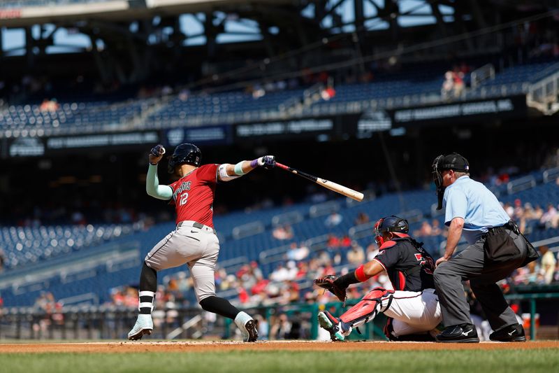 Jun 19, 2024; Washington, District of Columbia, USA; Arizona Diamondbacks outfielder Lourdes Gurriel Jr. (12) singles against the Washington Nationals during the first inning at Nationals Park. Mandatory Credit: Geoff Burke-USA TODAY Sports