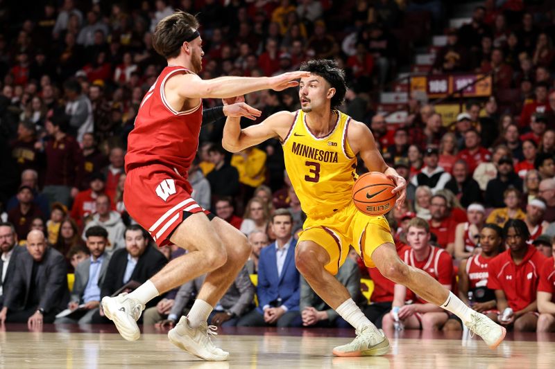 Mar 5, 2025; Minneapolis, Minnesota, USA; Minnesota Golden Gophers forward Dawson Garcia (3) dribbles as Wisconsin Badgers forward Carter Gilmore (7) defends during the first half at Williams Arena. Mandatory Credit: Matt Krohn-Imagn Images